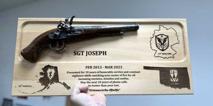 License Plate Plaque with Pistol | Trophy Center | Trophy Shop | ONLY in Kaiserslautern-Einsiedlerhof underneath Hacienda Mexican Restaurant | 2 MILES FROM RAMSTEIN AIR BASE | Engraving Custom Made Coin Challenge Coins Stamps Embroidery Guidons Awards Plaques Trophies Engraving Engraver Engraved Etched Signs Graveur Gravur  | Stempel Gravuren Pokale Schilder | USAREUR-AF | USAFE  | Nato | Bundeswehr |  Sandra Kulbick & J.R. Kulbick  |  WE ARE NOT AFFILIATED WITH ANY STORES ON BASE  |  ONLY in K-TOWN  | We Are Awesome | E-Mail: info@trophy-center.de